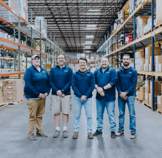 asTec Communications Group employees in warehouse demonstrating company benefits.