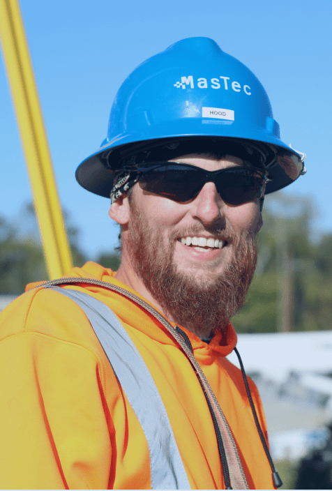 Telecom worker in safety gear representing MasTec Communications Group’s commitment to service.